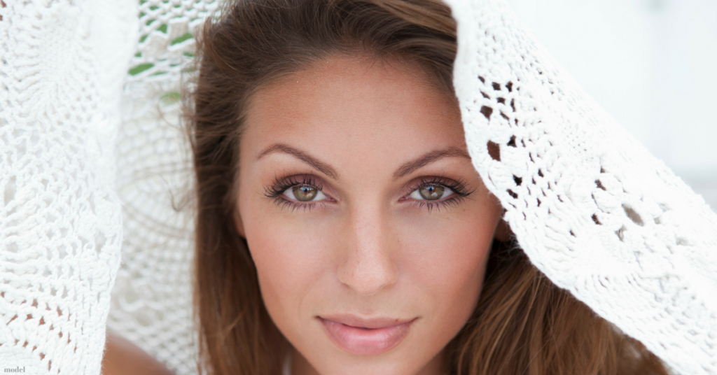 Young woman with a white lacy cloth over her head