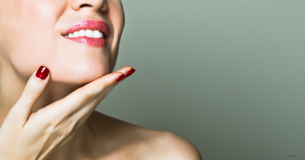 Woman's hand holding her chin