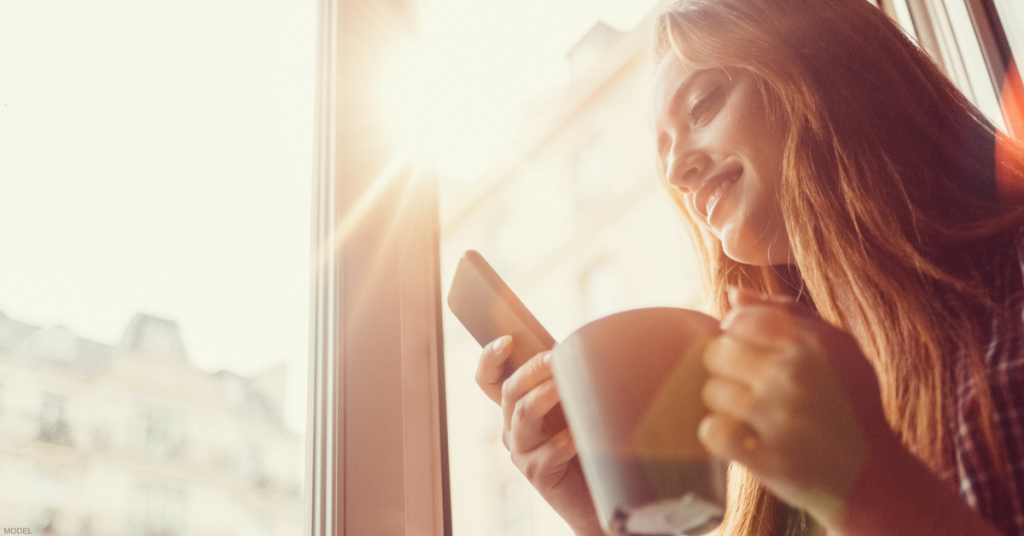 Woman next to a window.